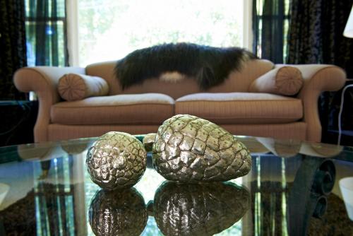 a cat laying on a couch with a glass table at Cambridge Cottage - Self Catering Holiday House in Cambridge