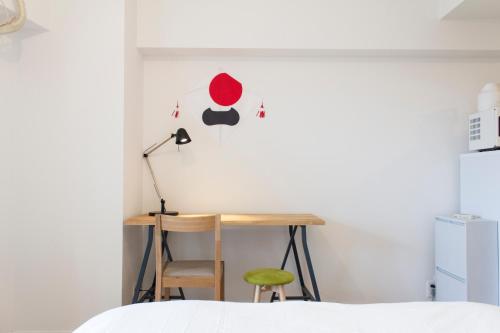 a bedroom with a desk and a lamp at Dwell Urban 7A in Tokyo