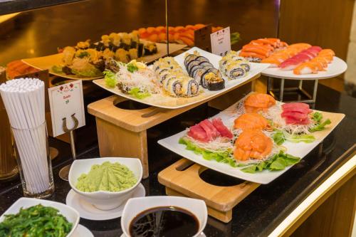 a buffet with different types of food on plates at Amaranta Hotel in Bangkok