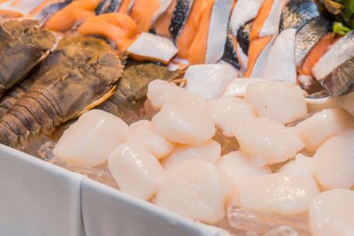 a tray of food with carrots and other foods at Amaranta Hotel in Bangkok