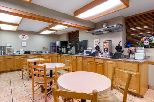 a restaurant with tables and chairs in a kitchen at Super 8 by Wyndham Cortez/Mesa Verde Area in Cortez