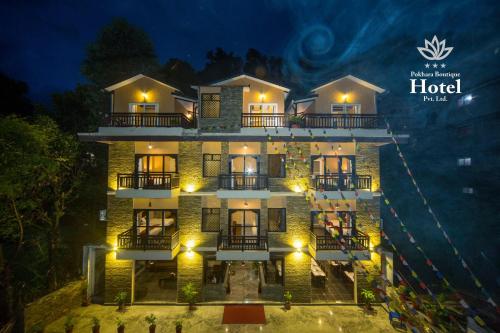 a hotel at night with the lights on at Pokhara Boutique Hotel in Pokhara