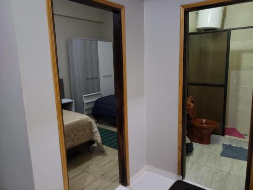 a mirror in a room with a bedroom at Class Apart Hotel in Encarnación
