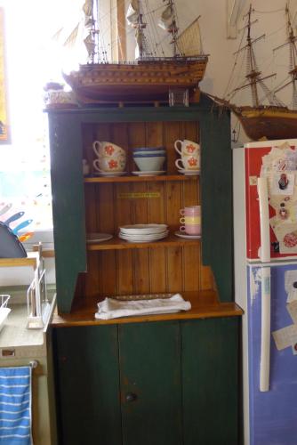 a wooden cabinet with a ship on top of it at The House Hostel in Sokcho