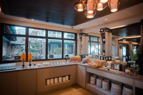 a restaurant with a counter with food on it at Boracay Mandarin Island Hotel in Boracay