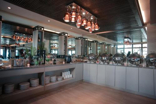 a restaurant with a counter with plates and bowls at Boracay Mandarin Island Hotel in Boracay