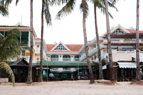 a hotel on the beach with palm trees at Boracay Mandarin Island Hotel in Boracay