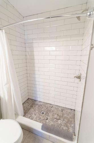 a bathroom with a shower with a toilet at Colony Suites in Palmer