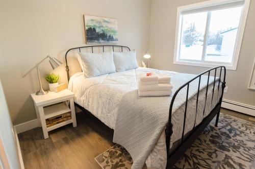 a bedroom with a bed and a window at Colony Suites in Palmer