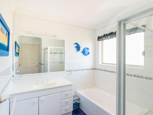 a white bathroom with a sink and a tub and a shower at Allure on Blueys in Blueys Beach