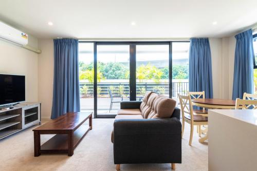 a living room with a couch and a table at The Edgerley Suites in Auckland