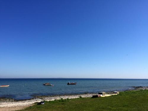 two boats in the water on a beach at Landhaus Habernis in Steinberg
