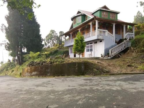 a house on the side of a hill at Vamoose Anugraha in Mangpu