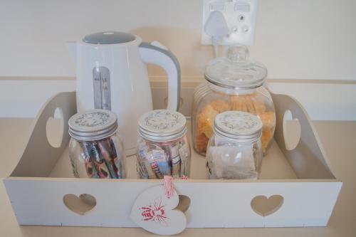 a drawer filled with jars and a blender at Melk Houte Bosch Guest Farm in Swellendam