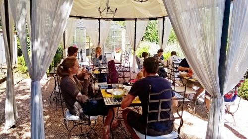 a group of people sitting at tables under a tent at Agriturismo Podere Santa Rita in Montescudaio