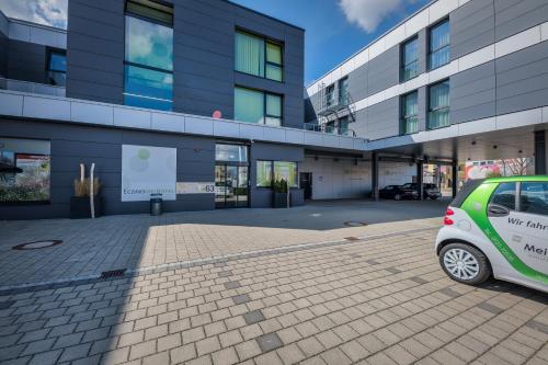 a small car parked in front of a building at Economy-Hotel in Ulm