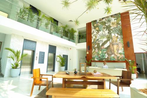 a room with a table and chairs and a painting on the wall at Morven Hotel Colombo in Colombo