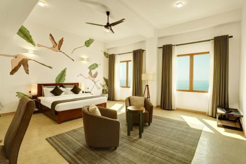 a bedroom with a bed with birds on the wall at Morven Hotel Colombo in Colombo