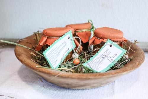 a wooden bowl filled with cookies and grass at HAUSERHOF - Urlaub auf dem Bauernhof in Villandro
