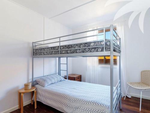 a bedroom with a bunk bed in a room at Pippis a Classic Beach House in Seal Rocks