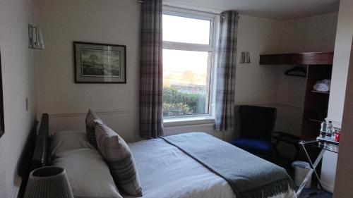 a bedroom with a bed and a window at geordie pride lodge in Liversedge