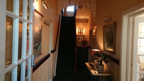 a hallway with a green staircase in a house at geordie pride lodge in Liversedge