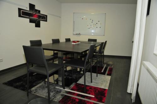 a dining room with a black table and chairs at Hotel Sporcher Nest in Cadolzburg