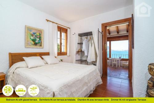 a bedroom with a bed and a balcony at SolHabitat Villa Big Blue in Benissa