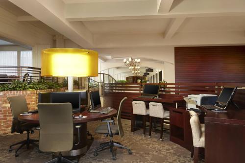 a waiting room with tables and chairs and a yellow light at Red Deer Resort & Casino in Red Deer