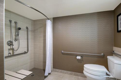 a bathroom with a toilet and a shower at Red Deer Resort & Casino in Red Deer