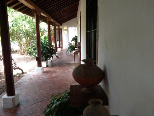a vase sitting on a table next to a building at Portal de la Marquesa in Mompos