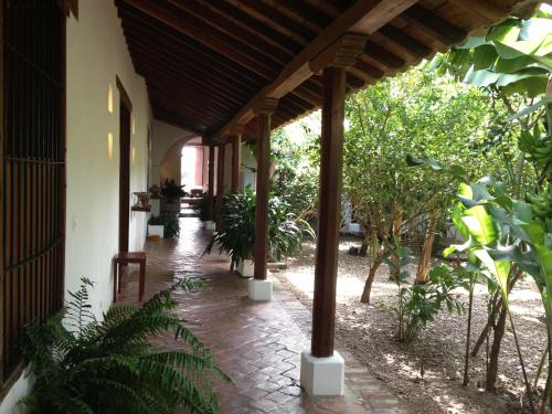 a porch of a house with a bunch of plants at Portal de la Marquesa in Mompos