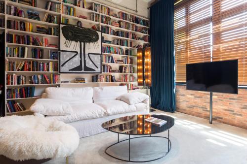 a living room with a white couch and a table at Stamba Hotel in Tbilisi City