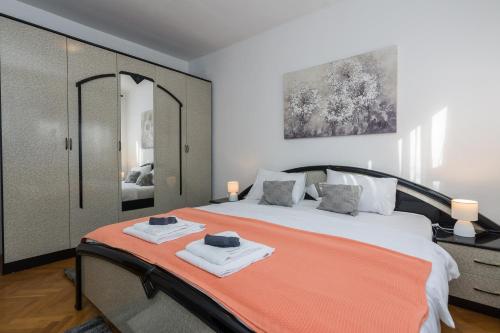 a bedroom with a bed with two towels on it at HOLIDAY HOUSE LAVANDA in Gornji Zemunik