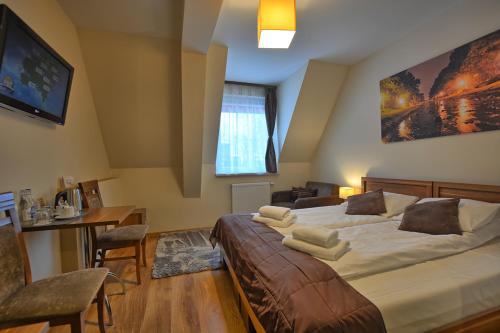Cama o camas de una habitación en Pensjonat Szajna Spa
