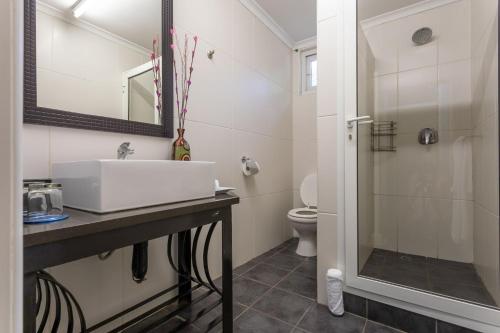 a bathroom with a sink and a toilet at Fallsway Apartments - Louden Court in Lusaka