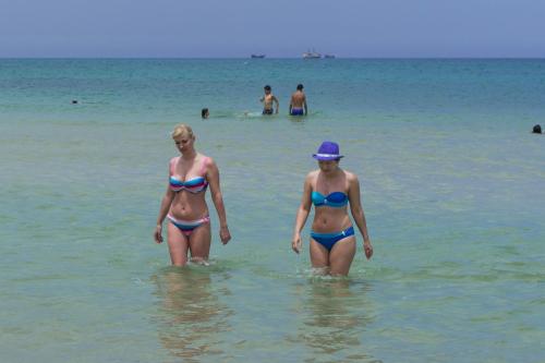 two women walking in the water at the beach at Hotel Dreams Beach in Hammam Sousse