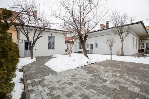 a house with snow on the ground at Old Town Courtyard Apartment with private parking in Cluj-Napoca