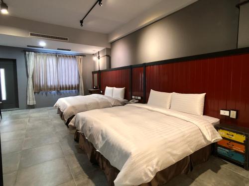 two beds in a hotel room with at Kenting True Color Hostel in Hengchun