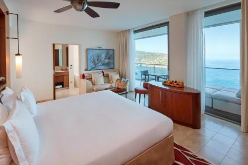 a bedroom with a bed and a view of the ocean at Jumeirah Mallorca in Port de Soller