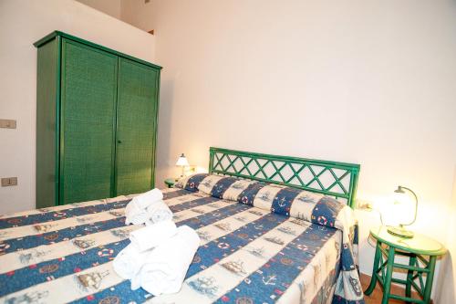 a bedroom with a bed with towels on it at Stella Marina Budoni in Budoni