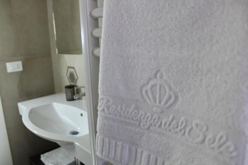 a bathroom with a sink and a white shower curtain at Residenza del Sele in Foggia