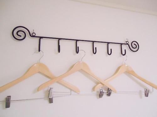 a group of hangers hanging from a rack at Shin-Okubo City Hotel in Tokyo