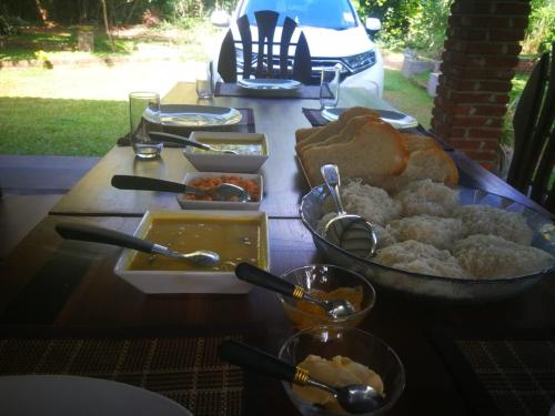 a table with a bunch of food on it at Green Cottage in Anuradhapura