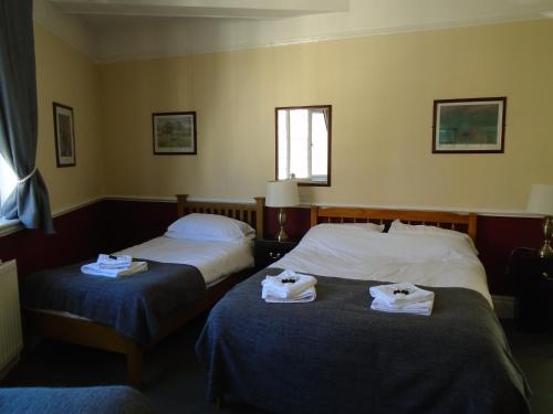 
A bed or beds in a room at The Swan Inn Pub
