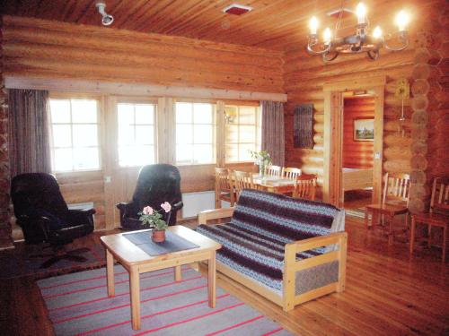 a living room with a couch and a table at Loma-Pälsilä lakeside villa in Kuhmoinen