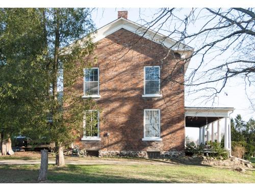 a brick house with white windows and a tree at Culverdene House in Simcoe