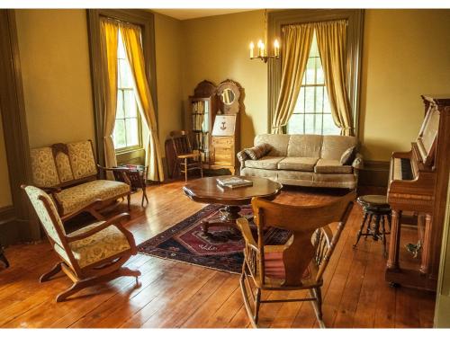 a living room with a couch and a table and chairs at Culverdene House in Simcoe