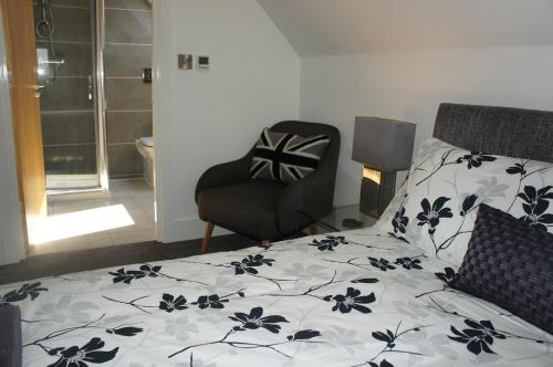 a bedroom with a bed with a black and white blanket at No 7 Woods View in Bournemouth