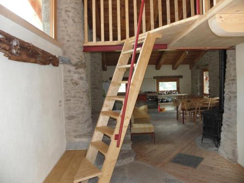 a wooden ladder in a room with a dining room at La vera casa di Mosè in Marmora